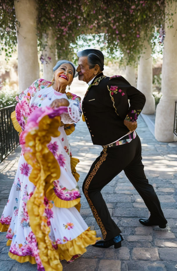 Elderly couple dancing joyfully in traditional attire outdoors