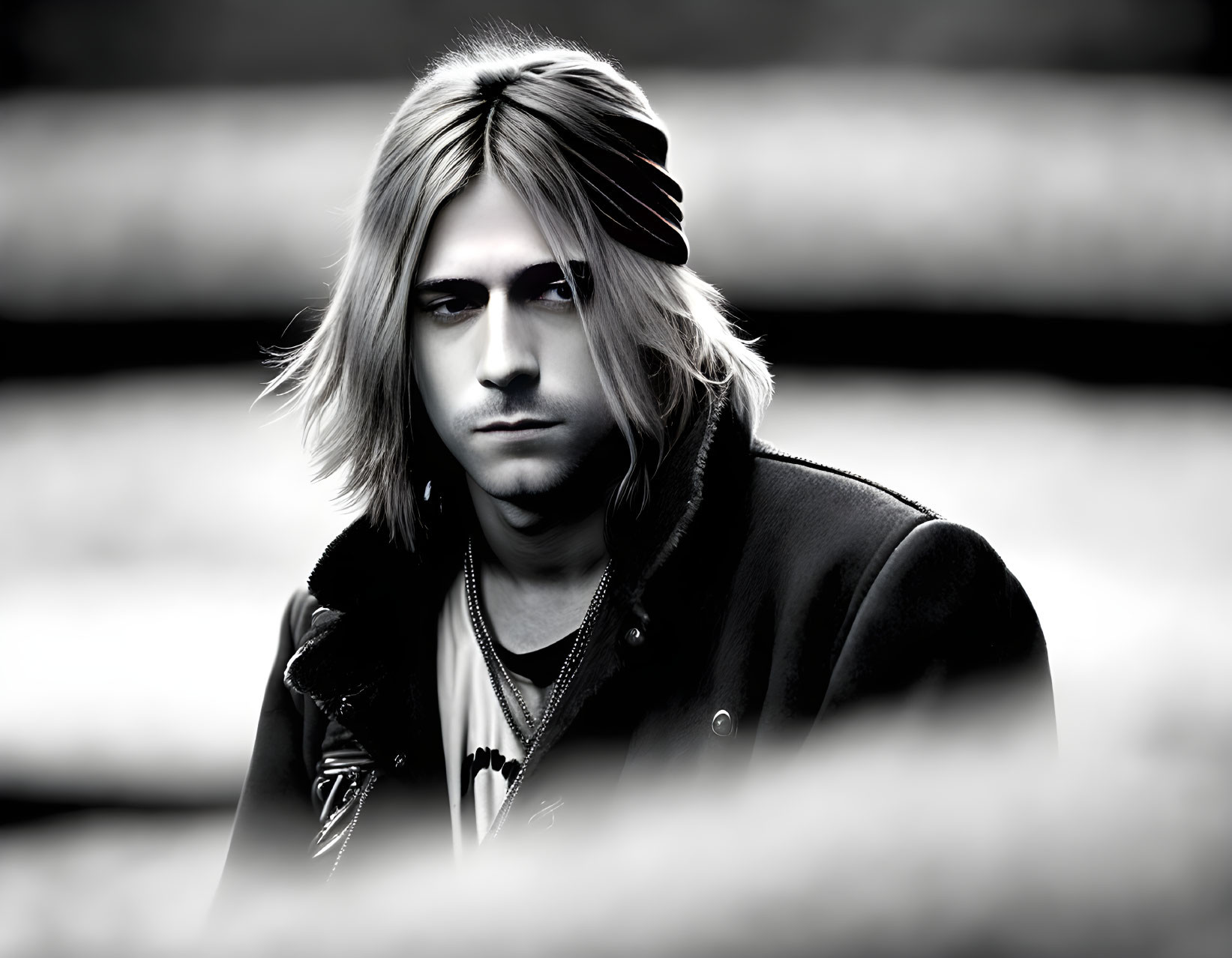 Monochrome portrait of long-haired person in headband and jacket