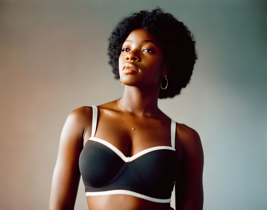 Confident woman in black and white bra with afro hair