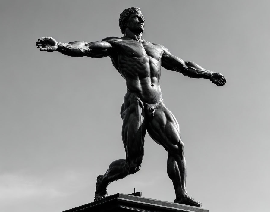 Monumental heroic statue in black and white against cloudy sky