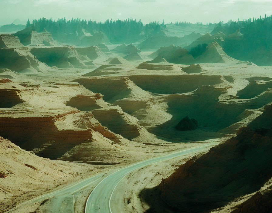 Barren landscape with winding road and sedimentary rock formations