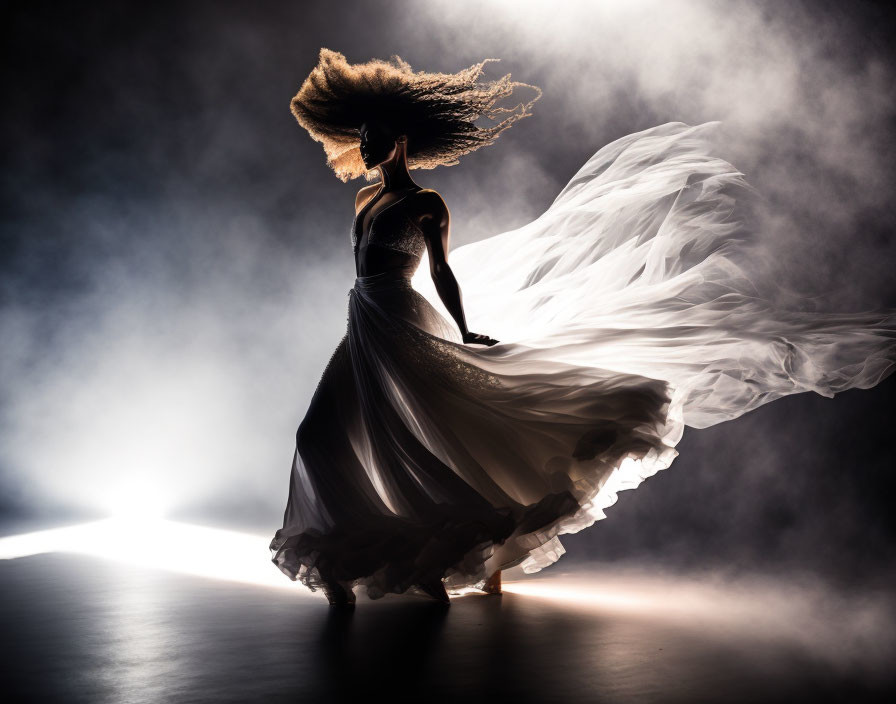 Silhouette of woman with flowing hair and dress in soft backlight