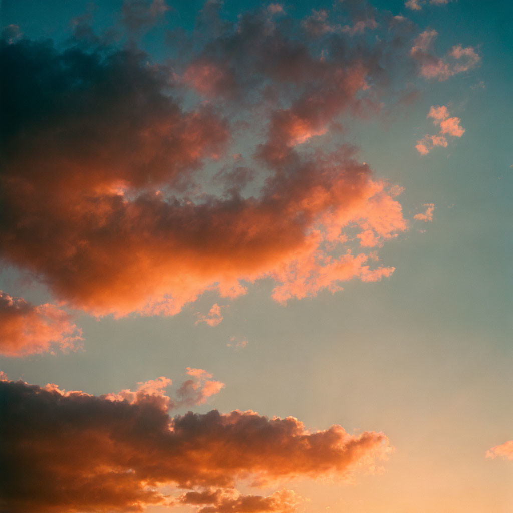 Tranquil sunset sky with blue, pink hues, and orange glow