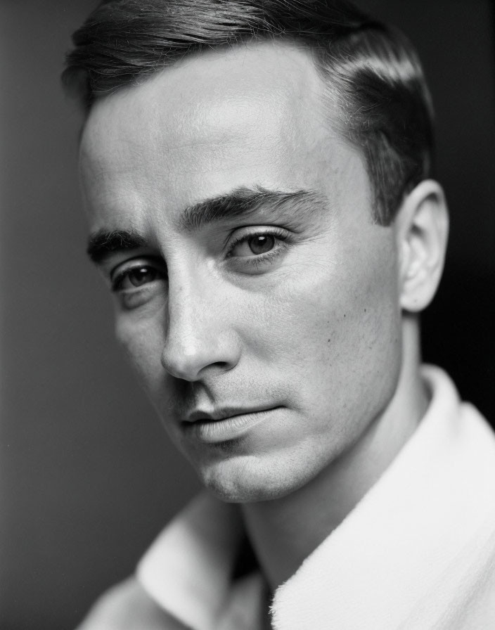 Monochrome portrait of man with short hair and defined cheekbones