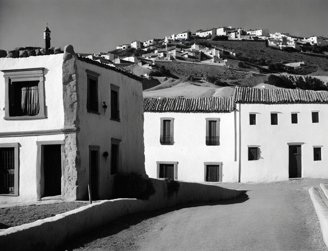 Traditional hilltop village with whitewashed buildings and winding street