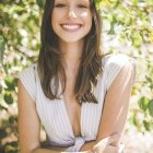 Woman in white dress under sunlight in lush greenery