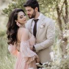 Romantic couple embrace in blooming garden with pastel colors