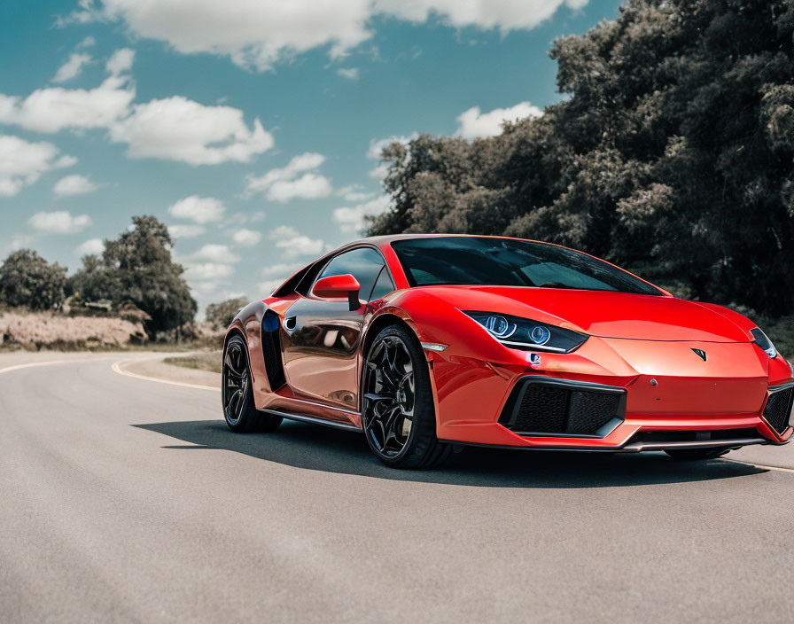 Red sports car parked on asphalt road under cloudy skies