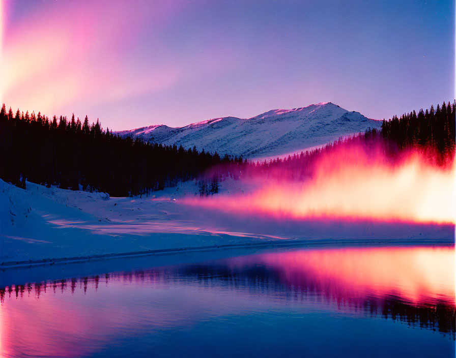 Tranquil mountain lake at dusk with pink skies and silhouetted trees