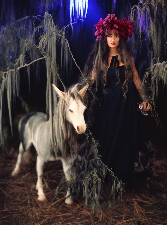 Woman in dark dress with floral headpiece near white unicorn in mystical forest.