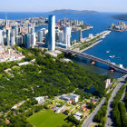 Coastal City Aerial View with Skyscrapers, Park, Cliff, and Ship Ent