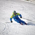 Animated character sliding down snowy slope with shield and spear