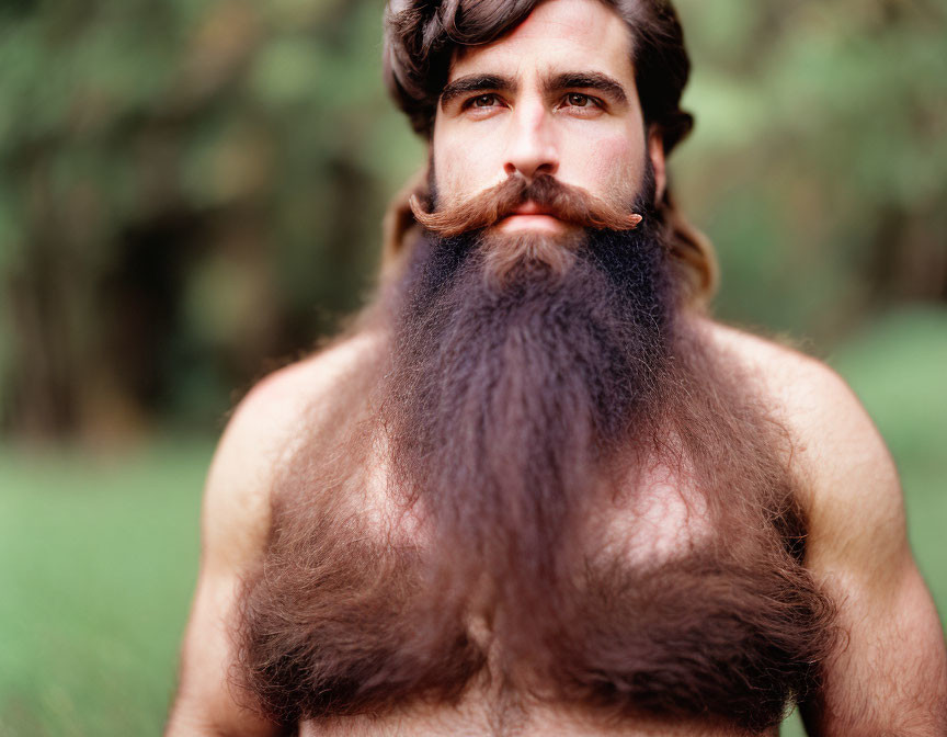 Bushy-bearded man with styled mustache on green background