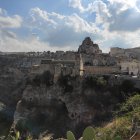 Detailed miniature castle in rocky terrain with trees, rivers, blue skies.