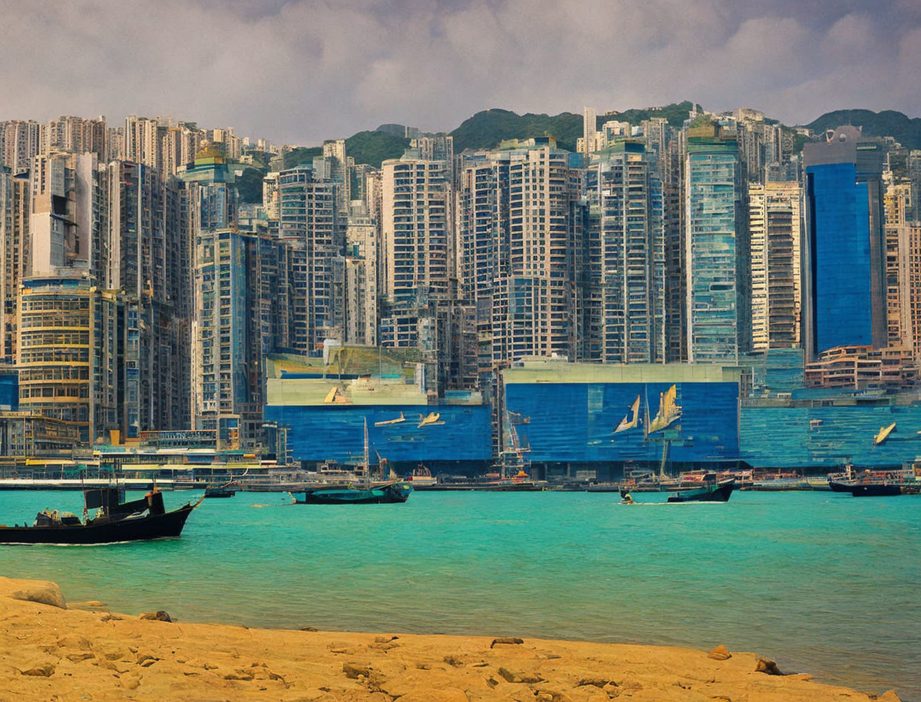 Urban skyline with high-rise buildings and traditional boats by the waterfront