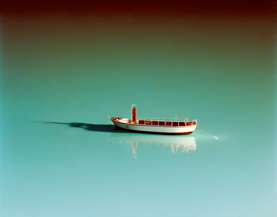 Red and White Boat Floating on Tranquil Teal Waters