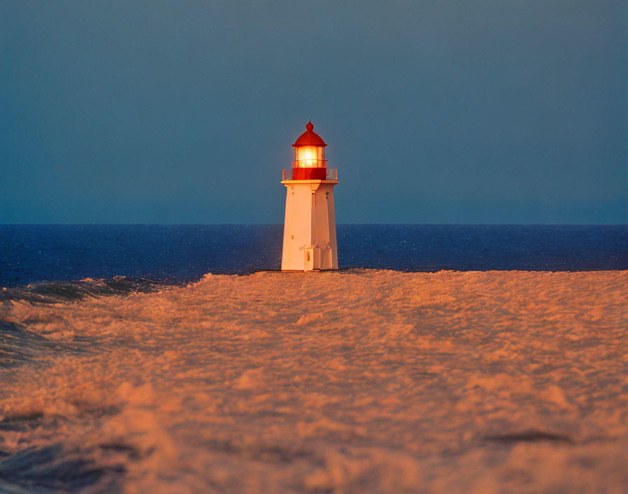 White Lighthouse with Red Top Against Seascape at Sunrise or Sunset