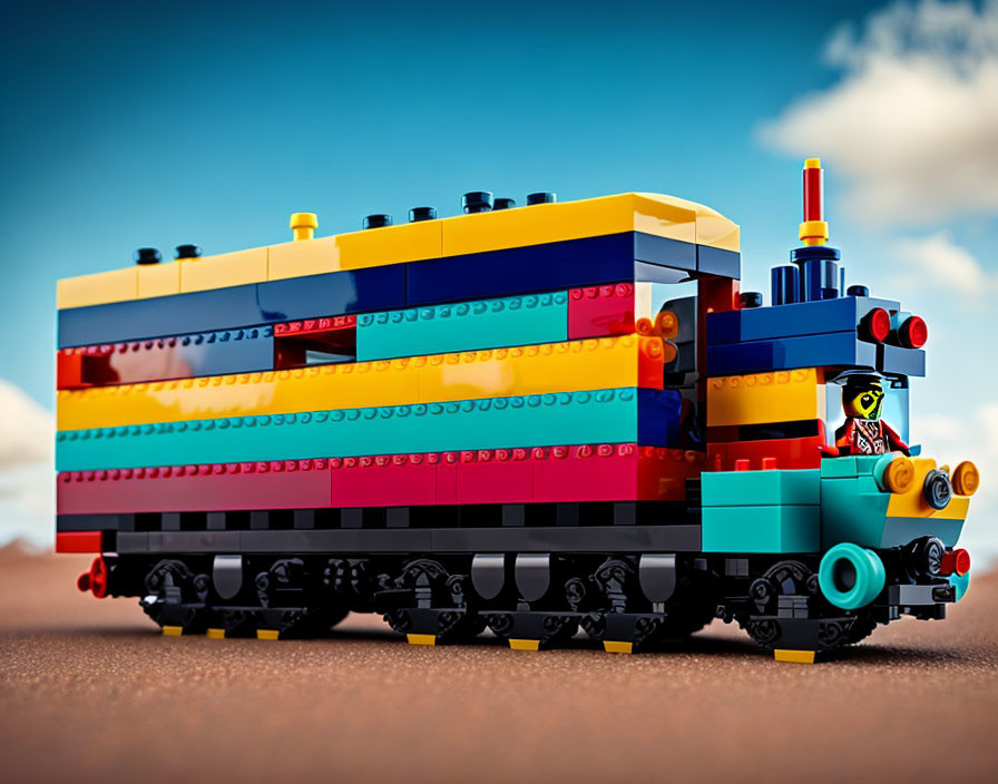 Colorful LEGO Toy Train with Pirate Figure on Sandy Beach Sky Background