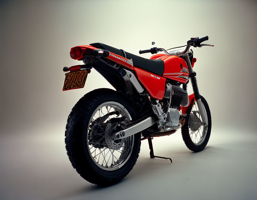 Vintage Red Off-Road Motorcycle with Raised Exhaust Pipe and Dual Rear Shocks
