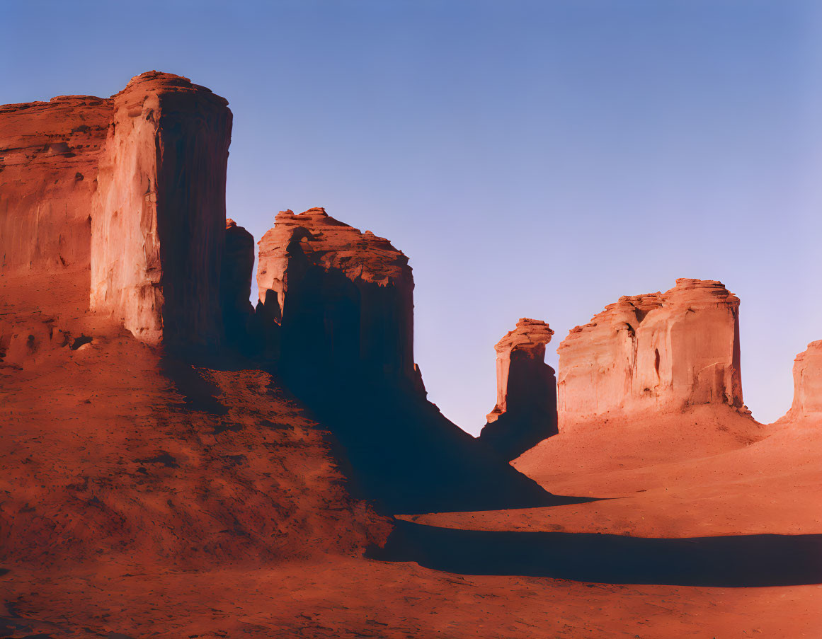 Red Sandstone Formations Cast Shadows in Desert Dusk