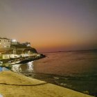 Colorful Watercolor Painting of Sunset Over Tranquil Sea