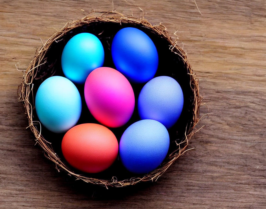 Colorful Nest with Blue, Pink, & Orange Eggs on Wood