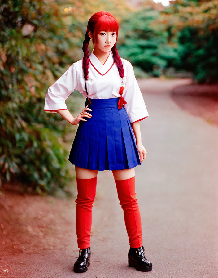 Cosplayer in white blouse, blue skirt, red tie & knee-high socks in nature setting