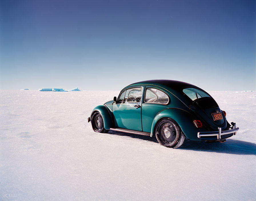 Vintage Volkswagen Beetle in snowy landscape with icebergs and blue sky