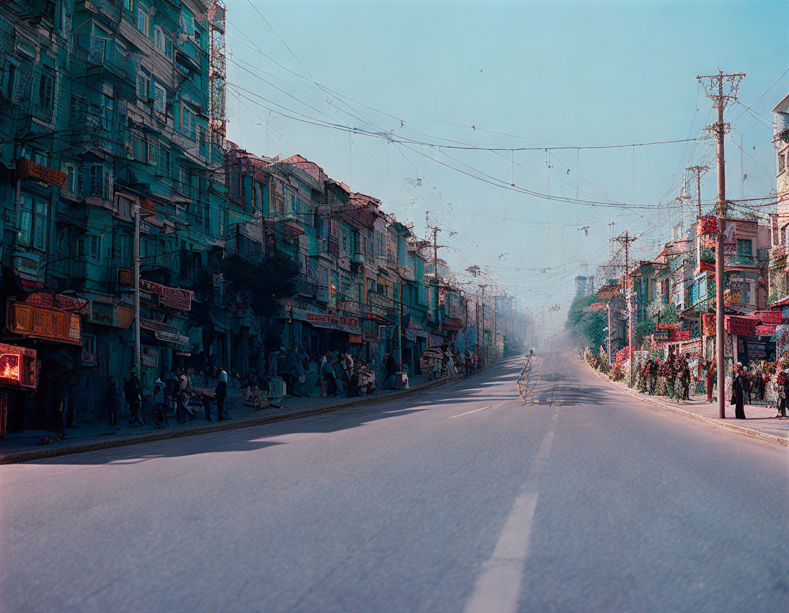 Colorful buildings and pedestrians on busy city street in daylight