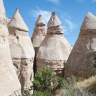 Surreal Landscape with Conical Rock Formations and Sky