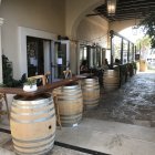 Charming Entrance with Wooden Barrels and Stone Pathway