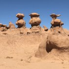 Sci-fi desert landscape with floating spherical structures and clear sky