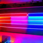 Vibrant neon lights in blue, pink, and red hues on wall