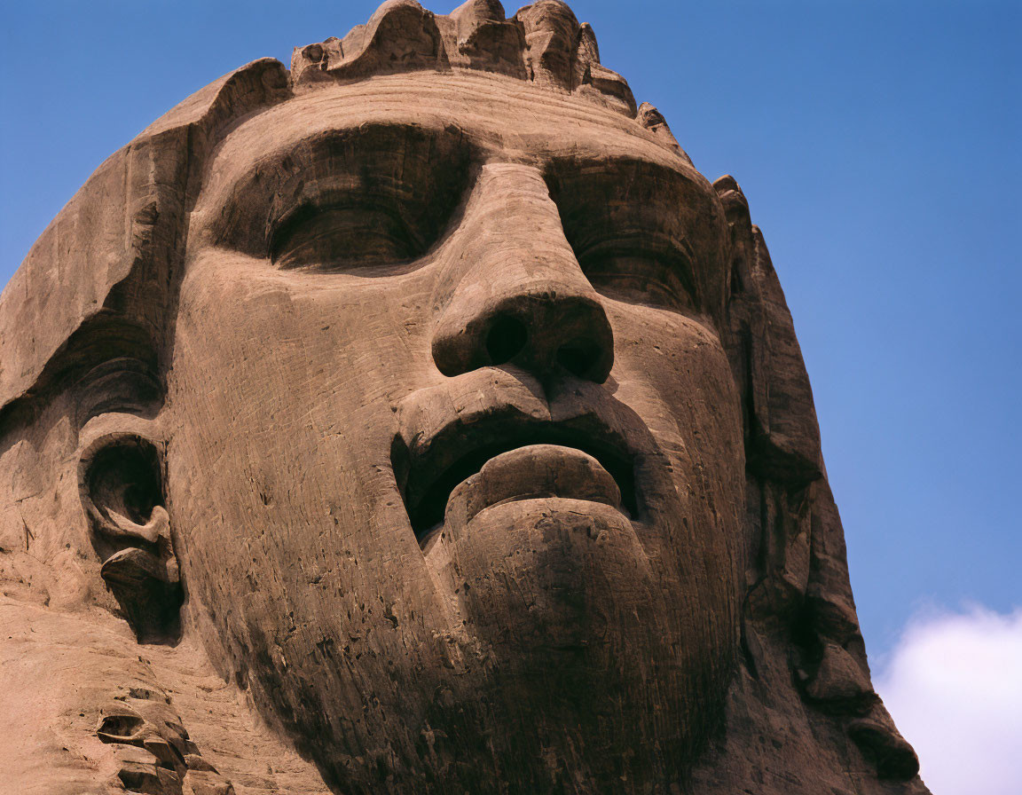 Weathered limestone features on Great Sphinx's face against blue sky