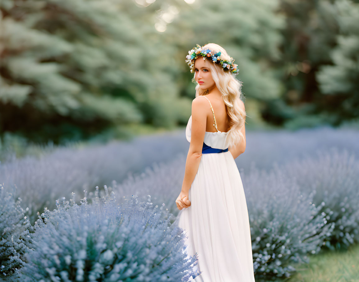 Woman in white and blue dress with floral crown in lavender field