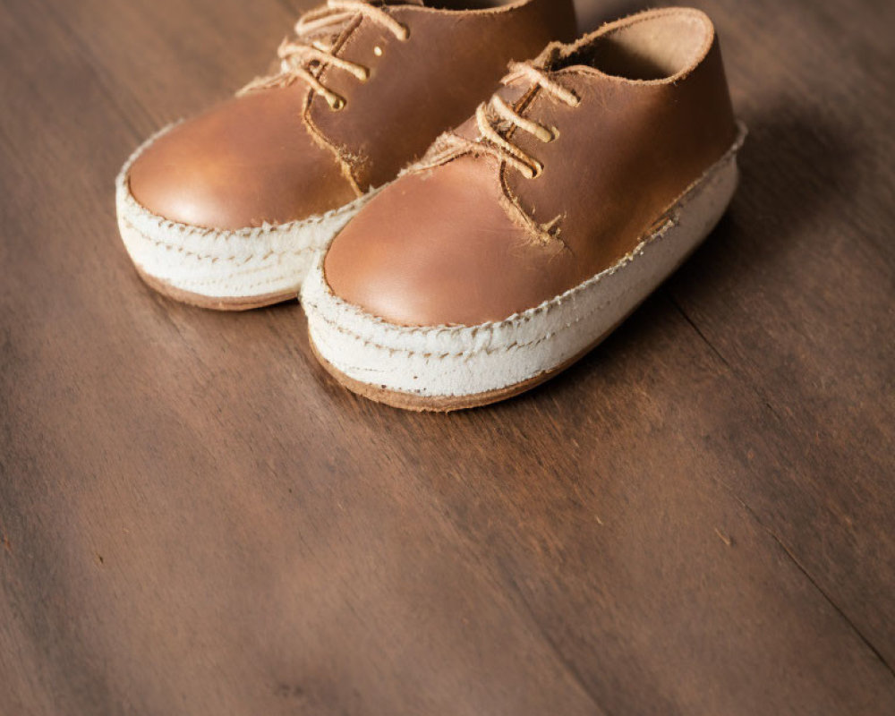 Brown Lace-Up Espadrilles with White Soles on Wooden Floor