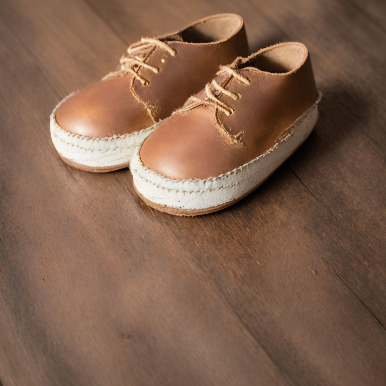 Brown Lace-Up Espadrilles with White Soles on Wooden Floor