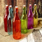 Decorative Bottles with Floral Designs on Wood and Metallic Leaves