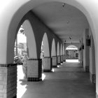 Elegant arched hallway with dining setup and framed pictures