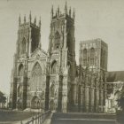 Gothic Cathedral with Vintage Cars and Crowded Scene