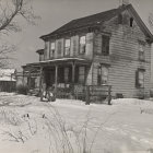 Victorian house with wrap-around porch in autumn setting