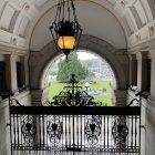 Serene Corridor with Figure in Blue Cloak and Quote