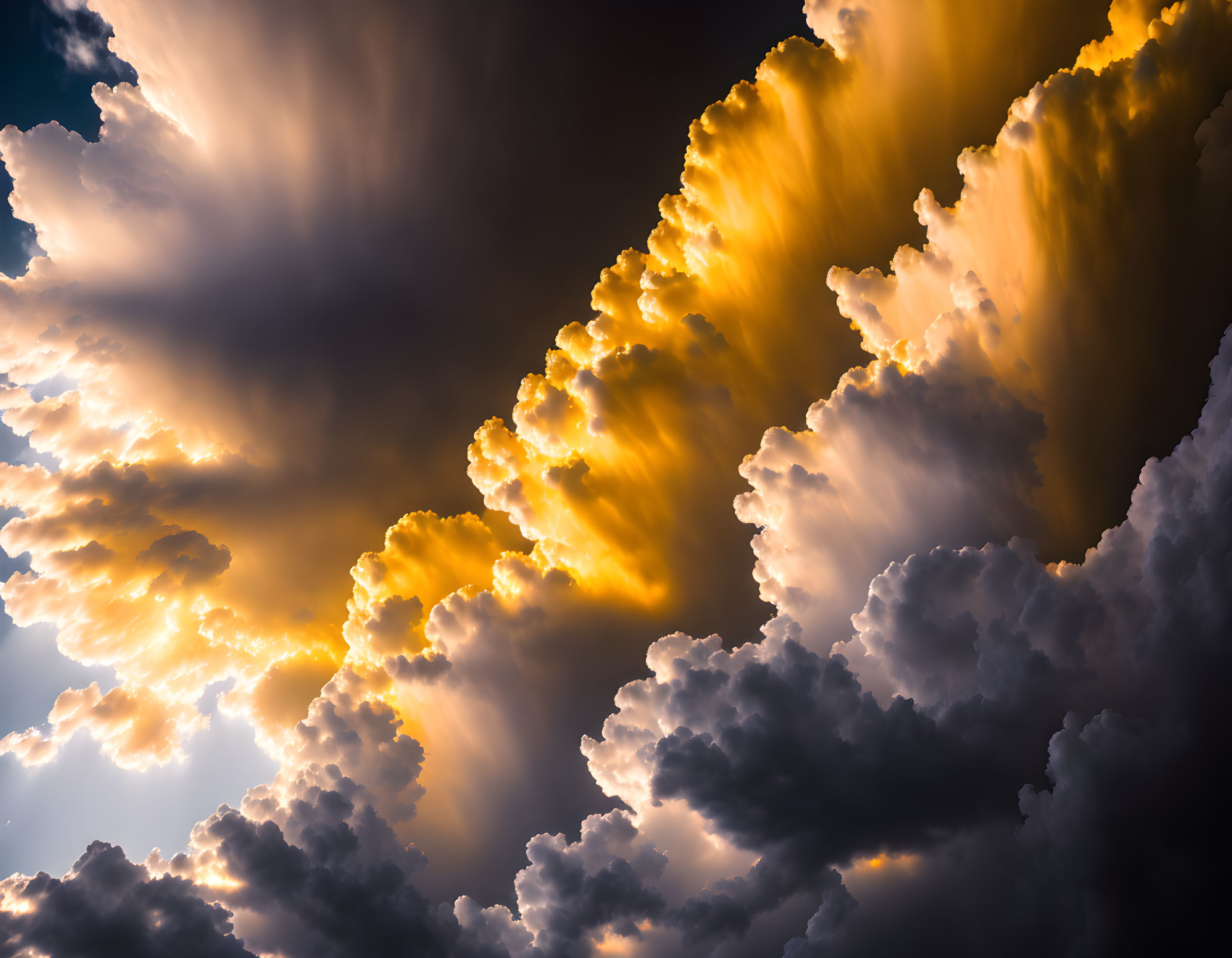 Dramatic sky with sunlit and shadowy clouds in warm tones