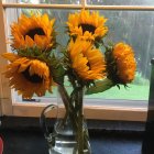 Colorful oversized flowers in orange and blue on a patterned table.