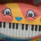 Vivid Illustration: Two Orange Cats Fused Over Piano Keyboard