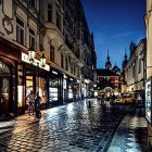 European Street at Night: Rain-soaked with City Lights and Full Moon