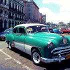 Vintage Turquoise and White Car in City Scene