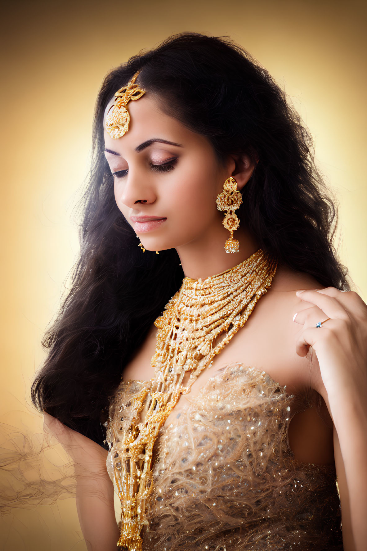 Elaborate gold jewelry on woman against warm backdrop