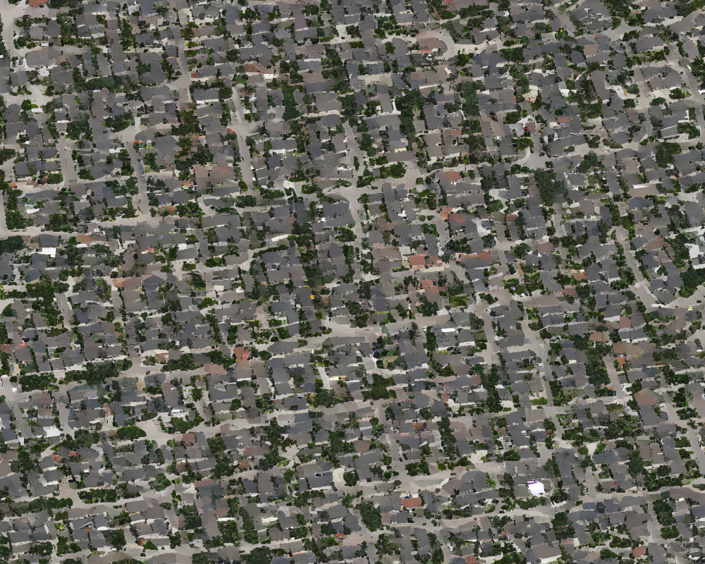 Dense Suburban Area with Houses, Trees, and Grid Streets