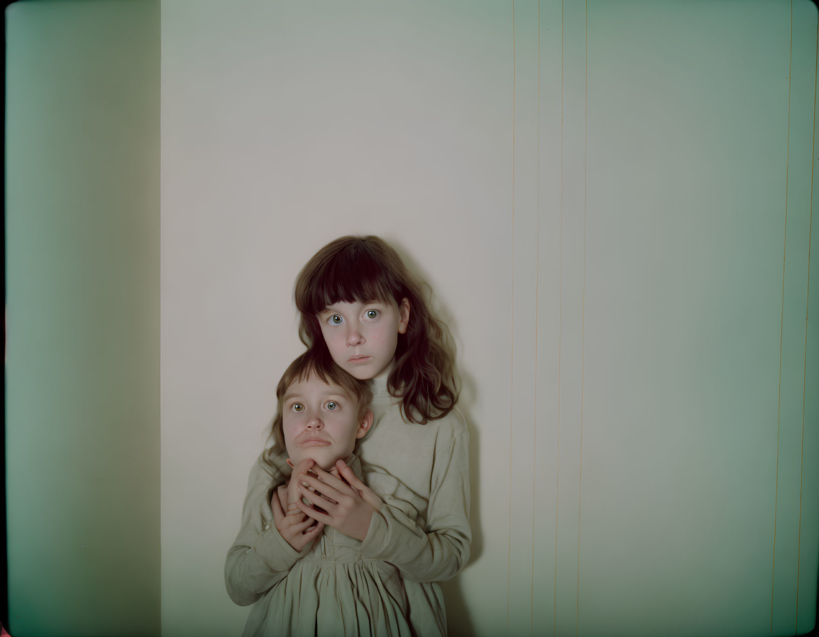 Girl embracing younger boy in heartwarming pose